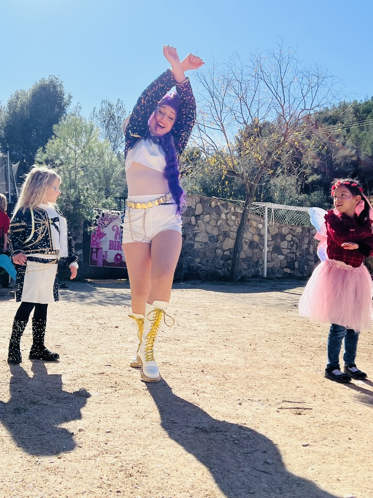 Performer dancing with children at a Paradise Stables birthday party