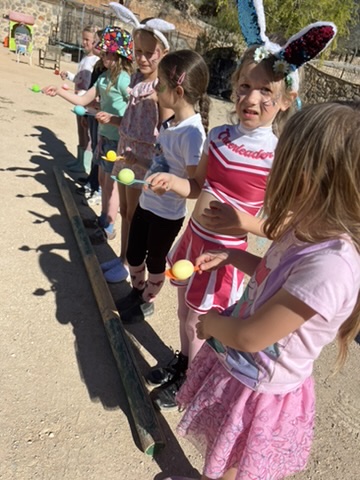 Children playing an egg-and-spoon race at a themed party at Paradise Stables