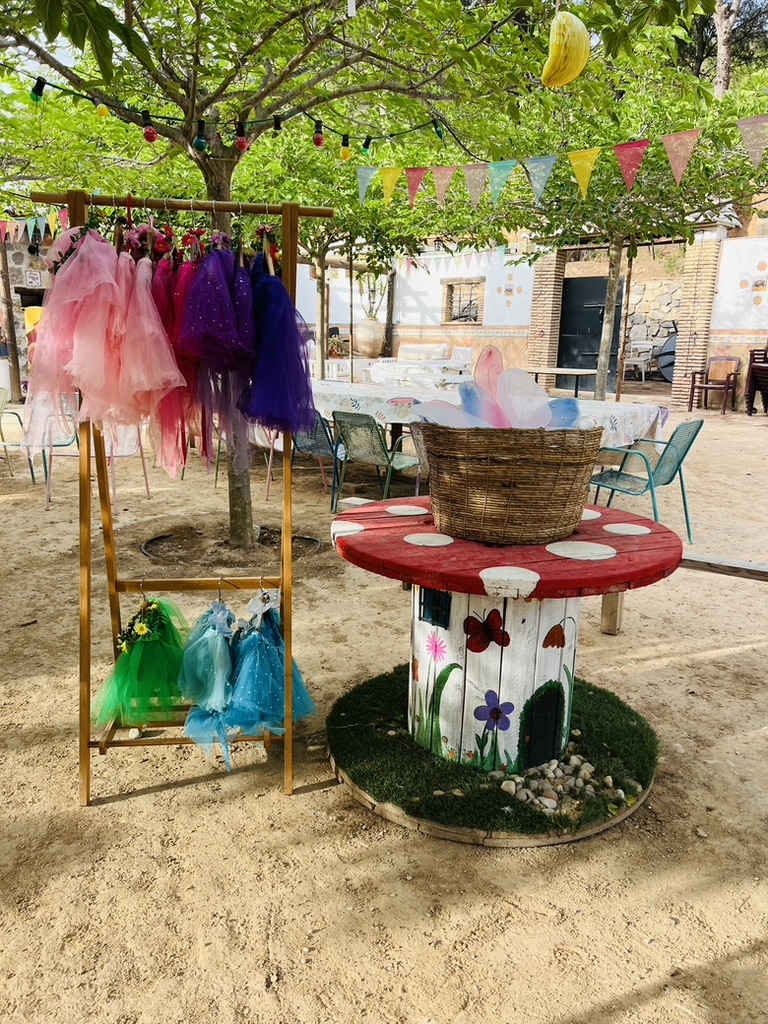 Tutu and fairy wing dress-up station under fairy lights at Paradise Stables