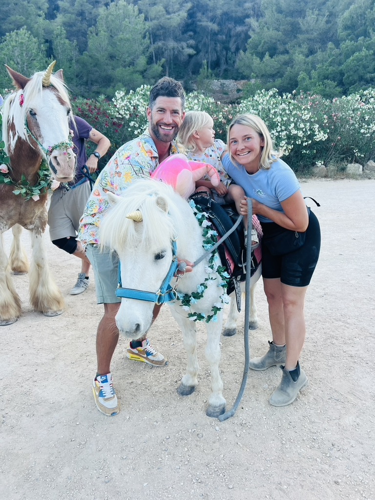 Family meeting a unicorn pony at Paradise Stables