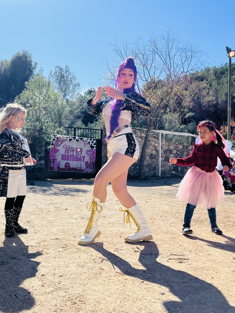 Performer dancing with children at a Paradise Stables birthday party